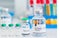 Dangerous drug warning sign biohazard,experimental concept treatment coronavirus or covid 19,medicine and vaccine in glass bottle