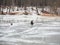 Dangerous fishing on wet spring ice. Fisherman on wet melting ice