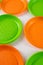 Dangerous green and orange disposable plates made of harmful plastic