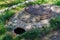 Dangerous pit of failed asphalt near the sewer manhole. Background with selective focus and copy space