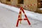 A dangerous place of falling of icicles is fenced with a ribbon