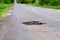 Dangerous pothole in the asphalt highway