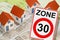 From dangerous road for cars to safe road for people - concept with zone 30 road sign,