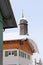 A dangerous roof avalanche on a house roof in front of a church in winter