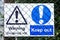 Dangerous site warning sign keep out behind wire fence