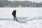 Dangerous thin ice. Man takes risk to step on frozen river surface in winter. Caution. unsafe water