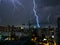 Dangerous thunderstorm with lightning in the night city