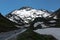 Dangerous turned road high in the Alps between melting snow