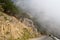 Dangerous winding road in the mountains in a fog