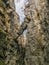 A dangerously overhanging rock in a crevice between the rocks