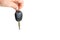 A dangling car key isolated on a white background.