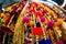 Dangling golden decorations with bells and puffs hanging in a store in chandni chowk delhi