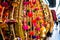 Dangling golden decorations with bells and puffs hanging in a store in chandni chowk delhi