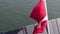 Danish Flag flying with water in the background