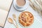 Danish pastries, coffee and note book on white wooden table