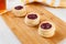 Danish pastry cake with cranberry jam on the table. Sunny breakfast