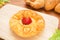 Danish pastry with strawberry on wooden plate