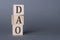 DAO characters. Decentralized autonomous organization. Written on three wooden blocks