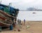 DAR ES SALAAM, TANZANIA - JANUARY 2020: Group of African Black People reparing Wooden fishing boat on the Coast of Dar