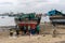 DAR ES SALAAM, TANZANIA - JANUARY 2020: Group of African Black People reparing Wooden fishing boat on the Coast of Dar