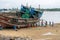 DAR ES SALAAM, TANZANIA - JANUARY 2020: Group of African Black People reparing Wooden fishing boat on the Coast of Dar