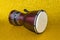 Darbuka on a yellow background two pieces. African drum toned