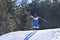 Daring 10-Year-Old Skier Catching Big Air in a Snowy Mountain Landscape