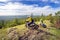 A daring motorcyclist on the top of the high Ural mountain sugomak is ready to go down on a summer sunny day