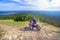 a daring motorcyclist on the top of the high Ural mountain sugomak is ready to go down on a summer sunny day