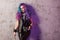 Daring rebel rocker, in black leather clothes with colored hair. Young stylish woman with trendy gradient toning hair