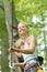 Daring woman wearing harness strapped to zip wire in trees