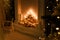 Dark aesthetic close up shot of decorative fireplace with wood, candles and shiny garland lights bokeh, fir branches. Merry