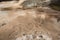 Dark amber geothermal pools over travertine rock, Yellowstone Na