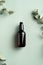 Dark amber glass bottle with serum and eucalyptus leaves on green background