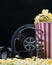 Dark background of cafe bar with popcorn and film, place for inscription, with movie title