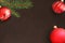 Dark background with Christmas fir branch, red and wavy dull ball