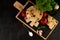 On a dark background, rigatoni pasta, tomatoes, basil, garlic, pepper, salt in a spoon.Homemade food concept