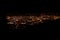 Dark background view of city with lights from aeroplane. Night lights in the city. Aeroplane view of dark nigh above the