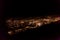 Dark background view of city with lights from aeroplane. Night lights in the city. Aeroplane view of dark nigh above the