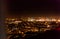 Dark background view of city with lights from aeroplane. Night lights in the city. Aeroplane view of dark nigh above the