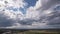 Dark beautiful clouds, dramatic sky over a beautiful valley. The clouds are moving forward. 4k timelapse.