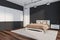 Dark bedroom interior with empty black wall, large bed