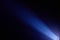 On a dark blue background diagonal bright ray of light