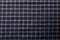 Dark blue checkboard pattern shirt fabric background, garment texture