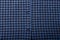 Dark blue checkboard pattern shirt fabric background, garment texture with buttons