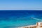 Dark blue clean bay water panorama on the Red Sea shore, spectacular clear landscape