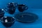 Dark blue crockery on blue wooden background