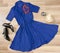 Dark blue dress and accessories arranged on the floor.
