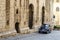 Dark blue Fiat 500 in front of an old building in the Italian city Gubbio, Italy