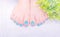 Dark blue green gel polish on toenail with cute design